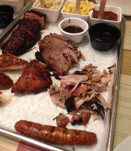 Share platter (beef brisket, pulled pork, chicken, chicken sausage, served with coleslaw, mac and cheese, and Texas beef chilli) along with pork rib tips.