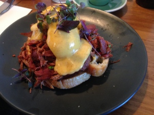 Sticky ham hock, fresh Asian herbs, chilli, black vinegar, tamarind hollandaise, and poached eggs on toasted sourdough